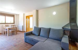 a living room with a blue couch and a stove at Beautiful Home In Caravaca De La Cruz With Kitchen in Caravaca de la Cruz