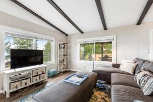 a living room with a couch and a flat screen tv at Hoodsport Hideaway in Hoodsport