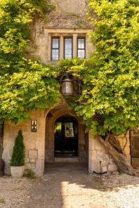 an entrance to a stone building with a tree at Kings Arms in Bradford on Avon