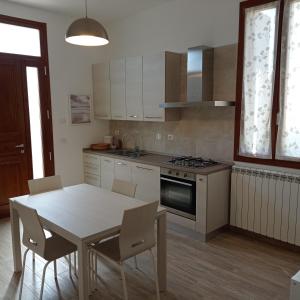 a kitchen with a table and a table and chairs at SANTA MARIA HOUSE in Empoli