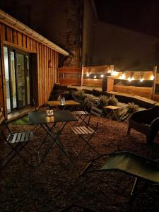 a living room with a couch and tables and lights at Gîte de charme : A la volette in Plombières-les-Bains