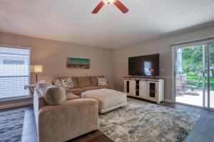 a living room with a couch and a flat screen tv at Hawkins Cove in Jacksonville