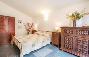 a bedroom with a bed and a wooden dresser at Stunning Apartment In La Spezia With 1 Bedrooms And Wifi in La Spezia