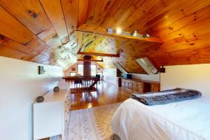 Stowe Hideout Unit 1 في ستو: غرفة بسرير وسقف خشبي