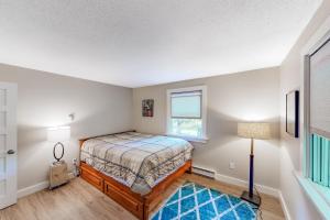 a bedroom with a bed and a window at Blueberry Cottage in Otter Creek