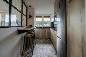 a kitchen with a counter and some windows at Alfonso X - Apartamentos Burgos Deluxe in Burgos