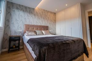 Postel nebo postele na pokoji v ubytování Alfonso X - Apartamentos Burgos Deluxe