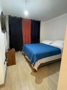 a bedroom with a bed and a tv in it at Edificio Gran Marino in Antofagasta +14 photos