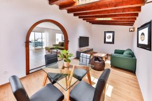 ein Wohnzimmer mit einem Glastisch und Stühlen in der Unterkunft Sea Sky Lanzarote in Playa Blanca