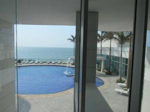 a view of a swimming pool and the ocean from a building at Palmetto2803 in Cartagena de Indias