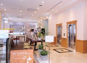 a lobby of a store with a table and chairs at Hotel Sunroute Taipei in Taipei