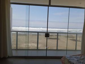 um quarto com vista para a praia a partir de uma janela em Casa de Playa VISTAMAR con Piscina, Camaná - Arequipa em Los Cerrillos