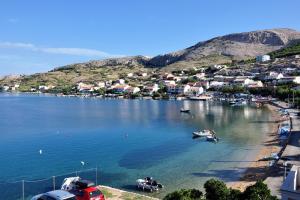a group of boats in a body of water at Double Room Metajna 6487d in Metajna