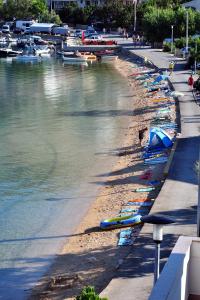 a row of boats are lined up on the beach at Double Room Metajna 6487d in Metajna