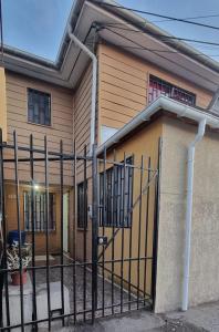 a house with a gate in front of it at Casa Enea Pudahuel in Santiago