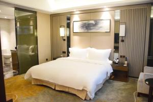 Postel nebo postele na pokoji v ubytování Ramada Foshan Hotel