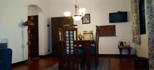a living room with a table and a dining room at Wilson Bungalow Kandy in Kandy