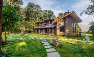 a house with a stone pathway in front of it at Hotel Eagles Nest in Dharamshala