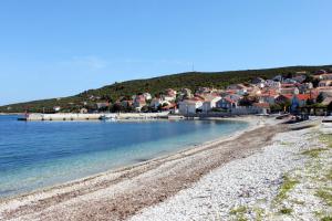 a view of a beach with houses and the water at Seaside holiday house Unesic - Unije, Losinj - 8045 in Unije
