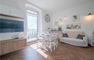 a living room with a tv and a table and a couch at 2 Bedroom Cozy Home In Camogli in Camogli