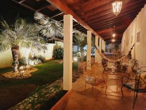 a porch with chairs and a hammock on it at Spa Belo Quinto Prime in Brotas