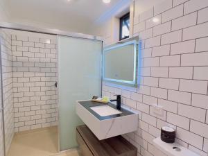 a bathroom with a sink and a mirror at Sandpiper Motel Apollo Bay in Apollo Bay