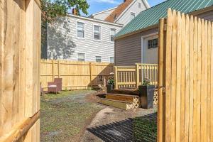a wooden fence in front of a house at NEW!! Lovely unit w/ PRIVATE Hot Tub and patio! in Laconia