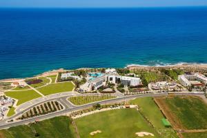 
a large green and white house on a beach at Azia Resort & Spa in Paphos
