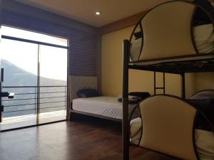 a bedroom with a bunk bed and a balcony at CASA DE CAMPO INTI PACHA Coroico 