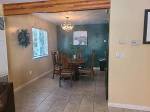 a dining room with a table and chairs and a chandelier at Sacred Mtn River Suites in Kernville