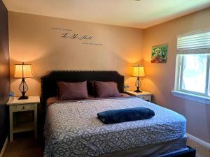 a bedroom with a bed with a blue pillow on it at Sacred Mtn River Suites in Kernville