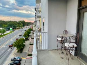 a balcony with tables and chairs and a street at Midtown Oasis by Luxe One -S57 in Atlanta