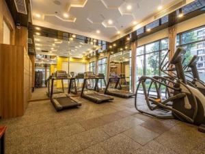 a gym with treadmills and ellipticals in a building at Apartment 1BR-FL12th-R103 Building-Vinhome Ocean Park in Hanoi