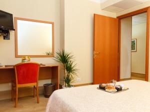 a bedroom with a table with a plate of food on it at Hotel Fortuna in Ancona