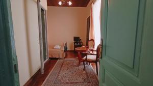 a hallway with a room with a bed and a table at Atheaton Traditional Guest Ηouse Nafplion in Nafplio