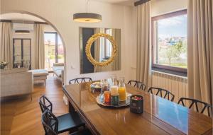a dining room and living room with a table and chairs at Awesome Apartment In Medulin With Outdoor Swimming Pool in Medulin