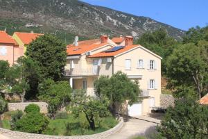 a large house in the middle of a mountain at Apartments with parking space Nerezine, Losinj - 2518 in Nerezine