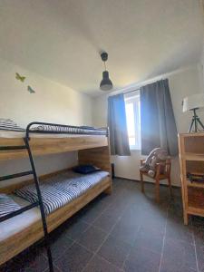 a bedroom with two bunk beds and a window at River House - Luxury house on the border of the Tisza River in Ároktő