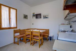 a kitchen with a table and chairs in a room at Apartments by the sea Nerezine, Losinj - 2519 in Nerezine