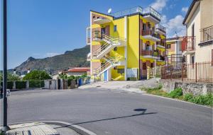 una calle vacía con un edificio de apartamentos amarillo en Cozy Apartment In Tortora With Wifi, en Tortora