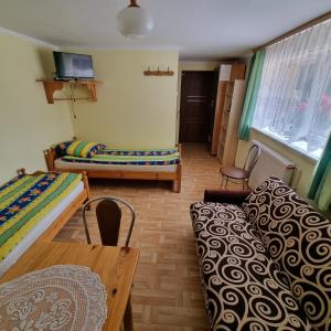 Postel nebo postele na pokoji v ubytování Kryniczanka