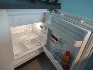 an open refrigerator with drinks and water bottles in it at Una finestra su Savona in Savona