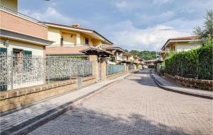 a cobblestone street with houses and a fence at 2 Bedroom Beautiful Home In Monterosi in Monterosi