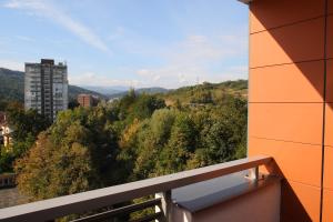 a balcony with a view of trees and a building at Hotel Mak in Gabrovo