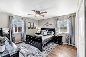 a bedroom with a bed and a ceiling fan at Serene 3 Bedroom Home, NRM, Wi-fi, Parking, Queen Bed in De Pere