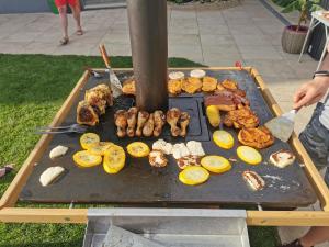 a grill with many different types of food on it at Appartements-Pension Lindenheim in Schladming