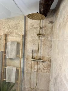 a shower with a shower head in a bathroom at CALANQUE D'EN VAU in Cassis