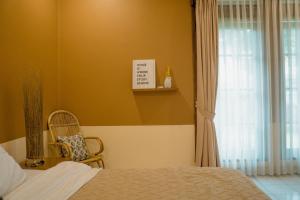 A bed or beds in a room at Roemah Renjana Bandung