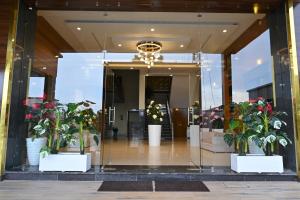 a lobby with potted plants in a building at Hotel Vasdaa Grand in Dehradun