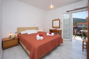 a bedroom with a bed with two towels on it at Diamanto Complex in Karavomylos